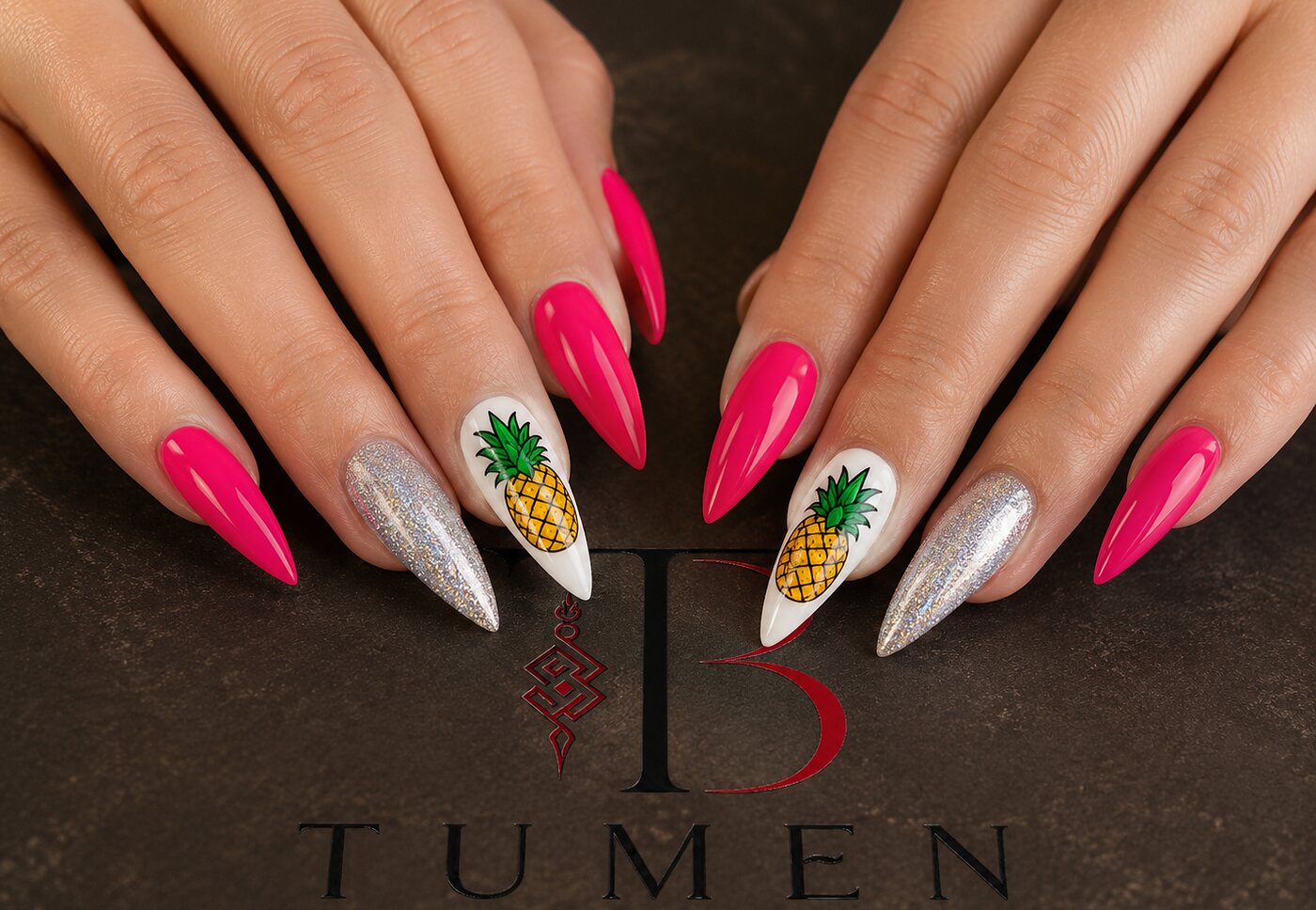 Long stiletto nails in hot pink and silver chrome with hand-painted pineapples