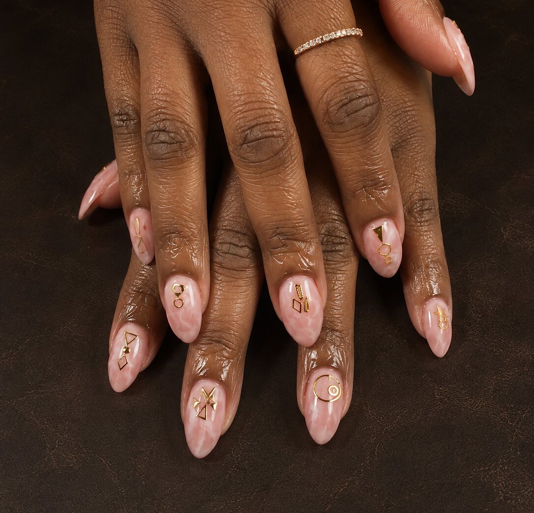 Nude overlay with fine gold foil detail on a ring finger